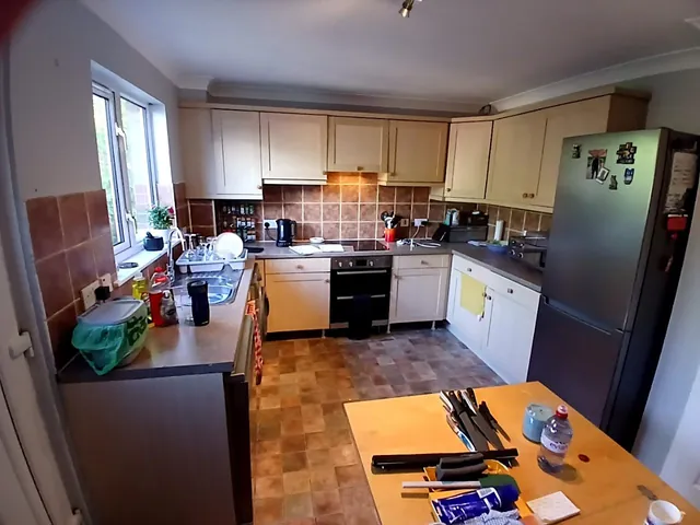Before: cream kitchen doors with a brown tiled splashback