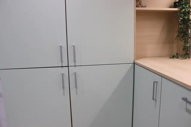 Wrapped tall units and end panels in grey green in our Cambuslang showroom