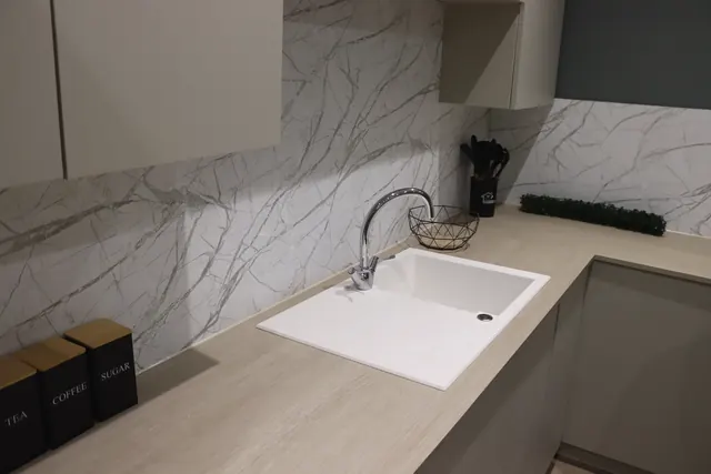 Marble-effect wrapped splashback above a sink
